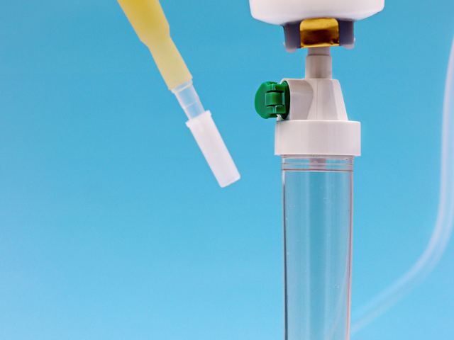 An intravenous giving set and syringes laid out ready for use.